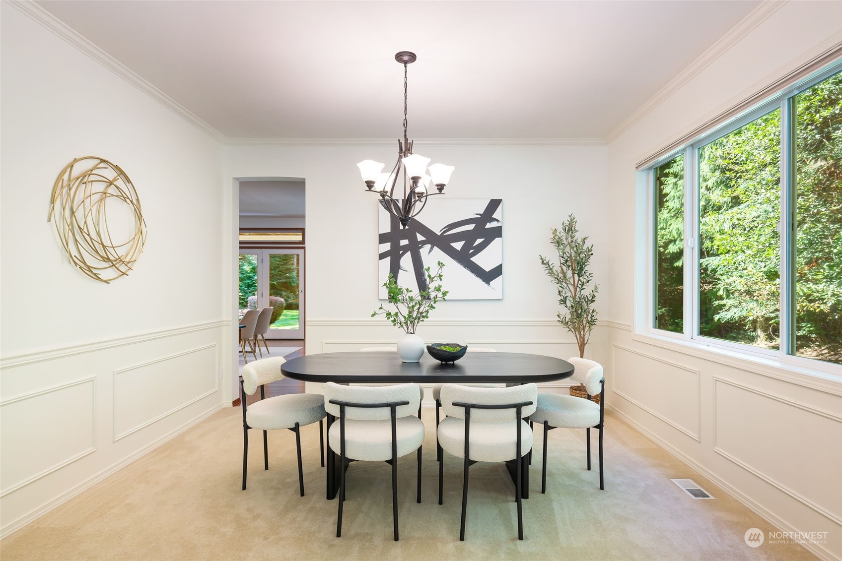 11227 Upper Preston Road Southeast Issaquah, WA 98027 - Photo 6 of 27 a dining room with furniture a potted plant and a chandelier