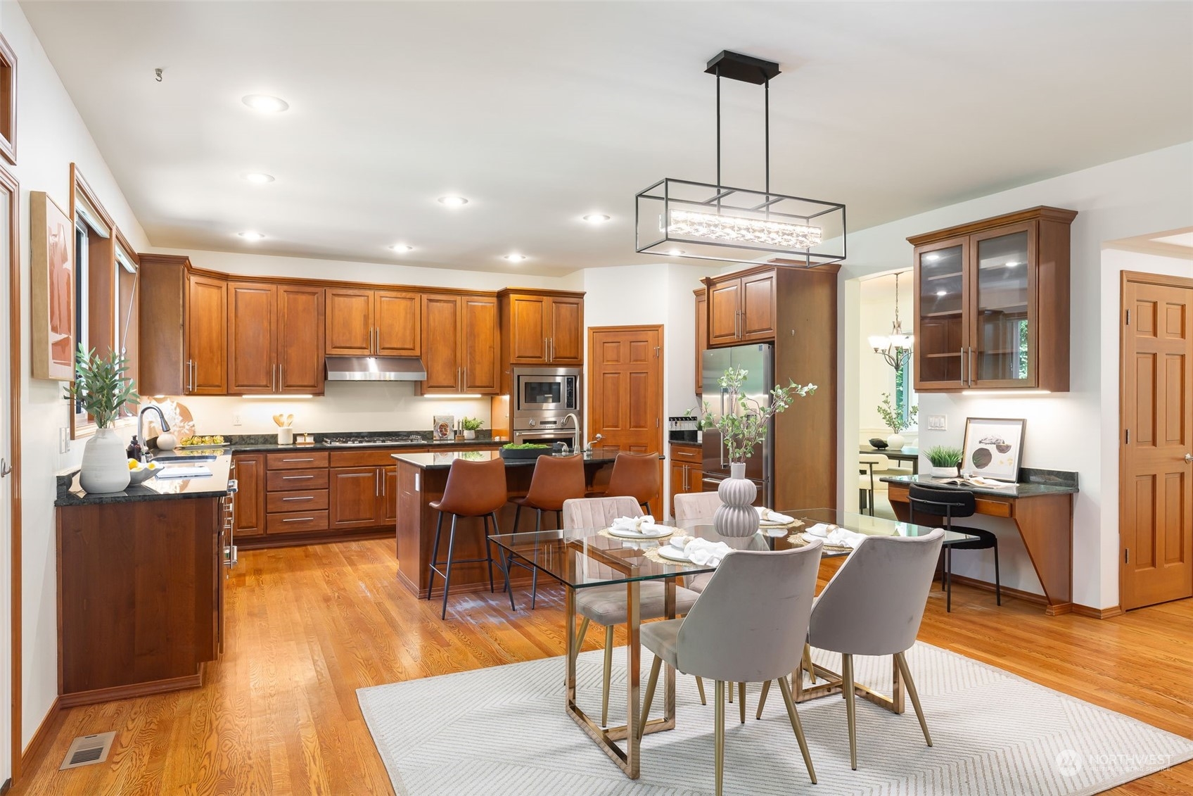 11227 Upper Preston Road Southeast Issaquah, WA 98027 - Photo 8 of 27 a dining room with stainless steel appliances kitchen island granite countertop a dining table chairs and window