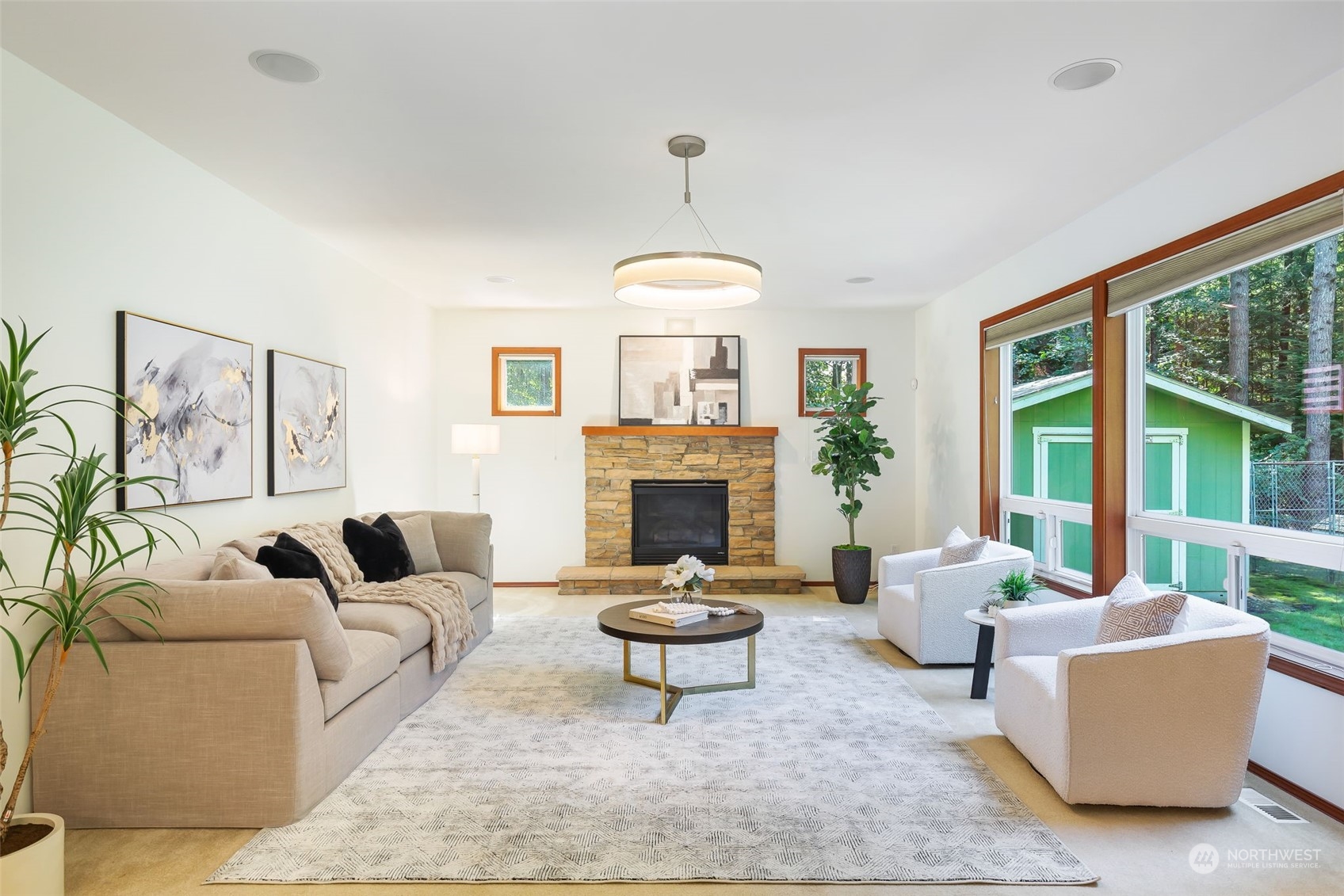 11227 Upper Preston Road Southeast Issaquah, WA 98027 - Photo 9 of 27 a living room with furniture a fireplace and a large window