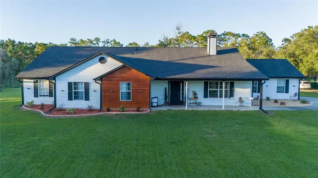 a front view of a house with a garden and porch