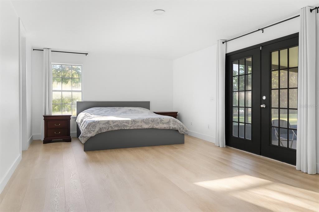 20107 Starry Street Orlando, FL 32833 - Photo 18 of 59 a bedroom with a large bed and a window