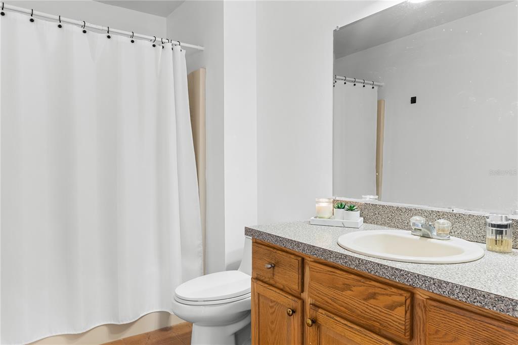 20107 Starry Street Orlando, FL 32833 - Photo 25 of 59 a bathroom with a granite countertop sink toilet and a mirror