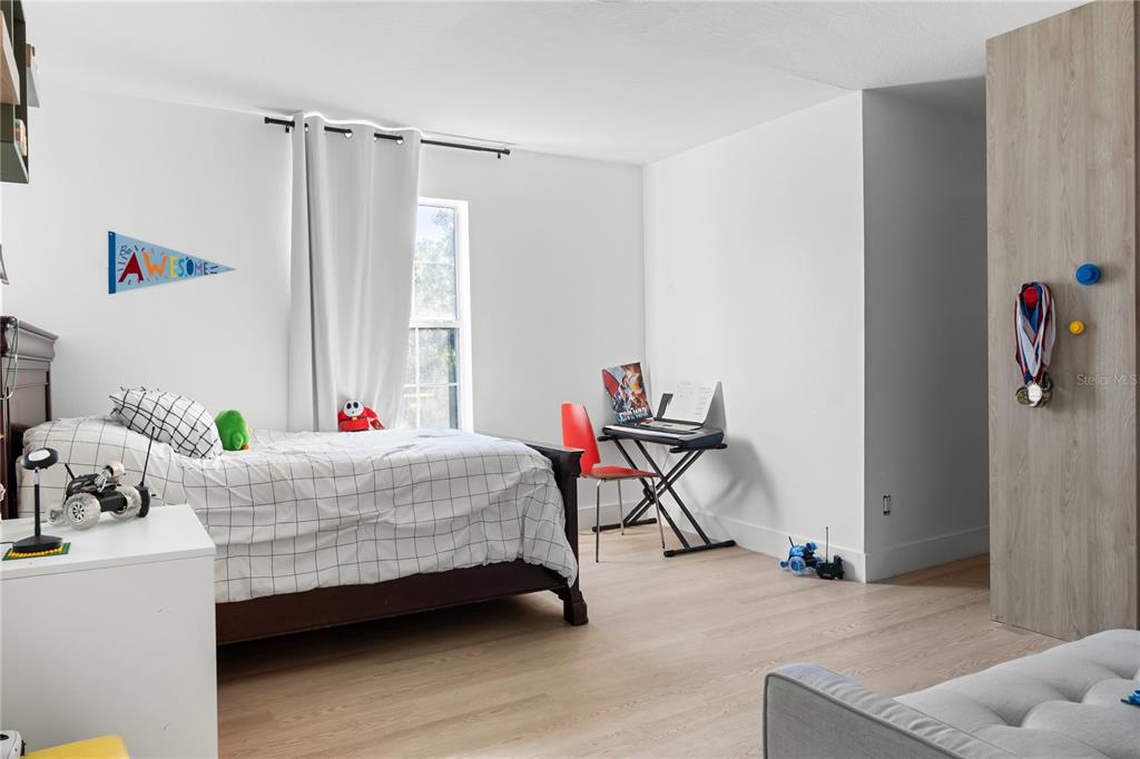 20107 Starry Street Orlando, FL 32833 - Photo 26 of 59 a bedroom with a bed and a window