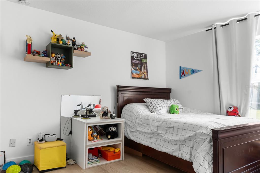 20107 Starry Street Orlando, FL 32833 - Photo 27 of 59 a bedroom with bed and a window