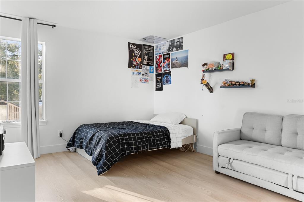 20107 Starry Street Orlando, FL 32833 - Photo 28 of 59 a bedroom with a bed and a couch