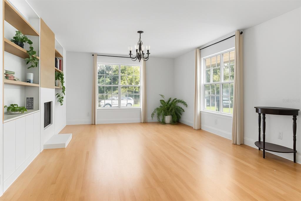 20107 Starry Street Orlando, FL 32833 - Photo 7 of 59 a view of an empty room with a window and wooden floor