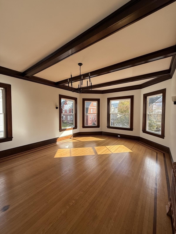 72 Belmont Street, Unit 1 Fall River, MA 02720 - Photo 12 of 20 an empty room with wooden floor and windows