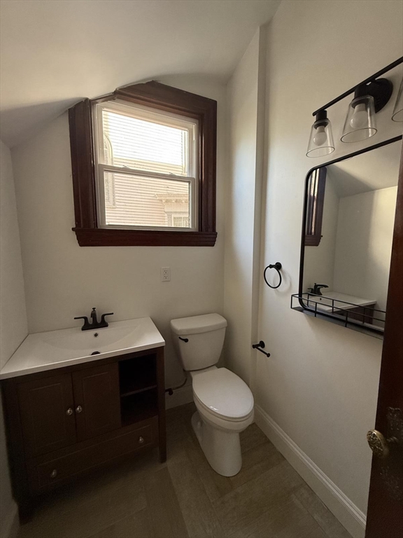 72 Belmont Street, Unit 1 Fall River, MA 02720 - Photo 19 of 20 a bathroom with a toilet sink and mirror