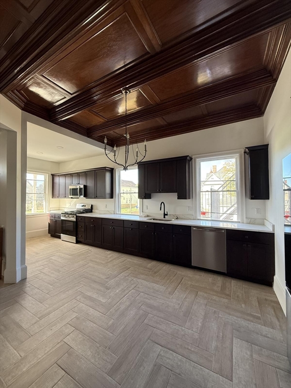 72 Belmont Street, Unit 1 Fall River, MA 02720 - Photo 2 of 20 a large kitchen with stainless steel appliances kitchen island granite countertop a large counter top and a microwave
