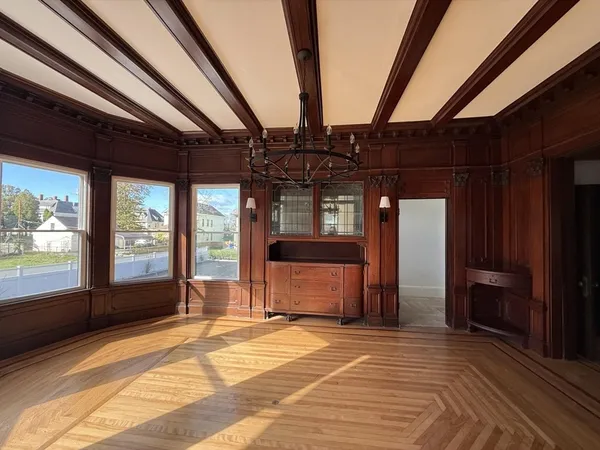 a view of a room with wooden floor and windows