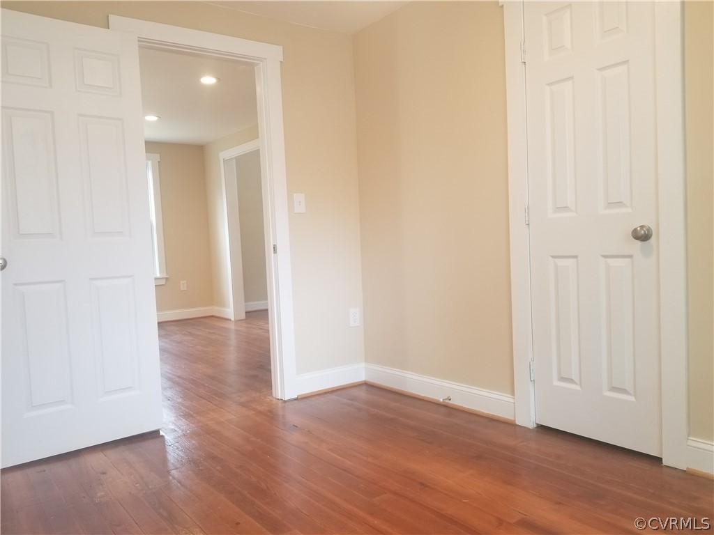 496 Johns Neck Road Weems, VA 22576 - Photo 8 of 20 a view of a hallway with wooden floor