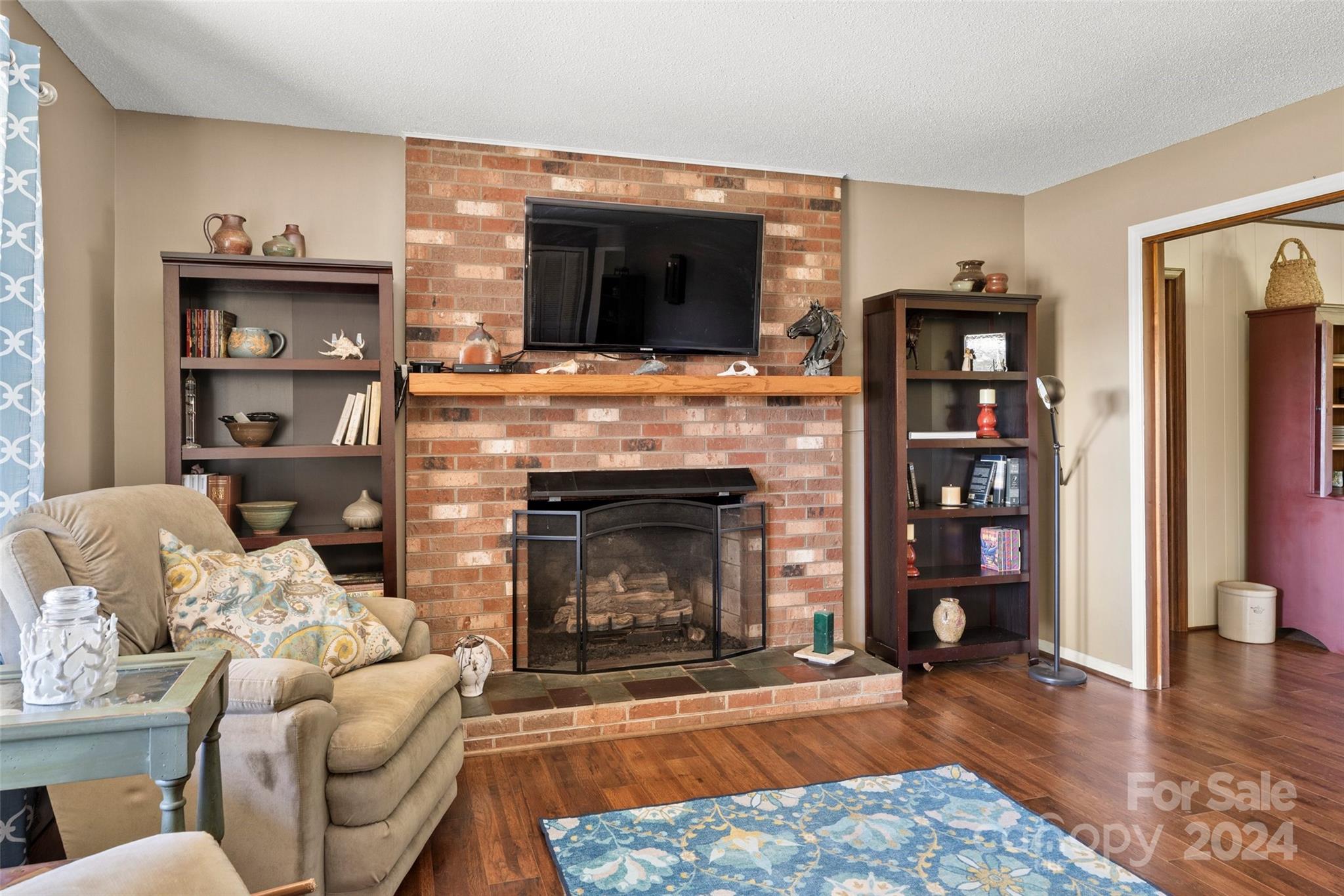 10845 Traphill Road Traphill, NC 28685 - Photo 18 of 48 a living room with furniture a flat screen tv and a fireplace