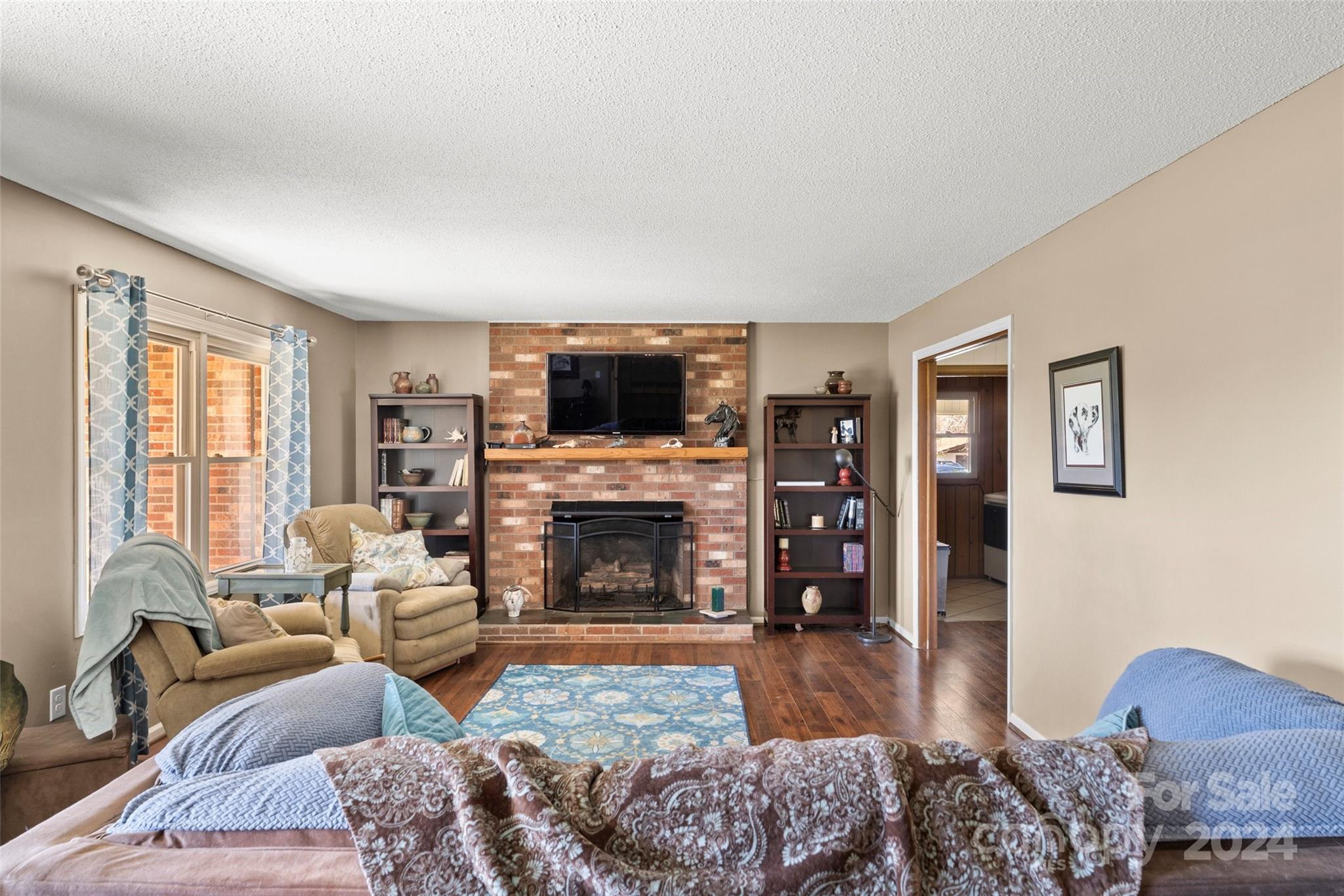 10845 Traphill Road Traphill, NC 28685 - Photo 19 of 48 a living room with furniture large window and a fireplace