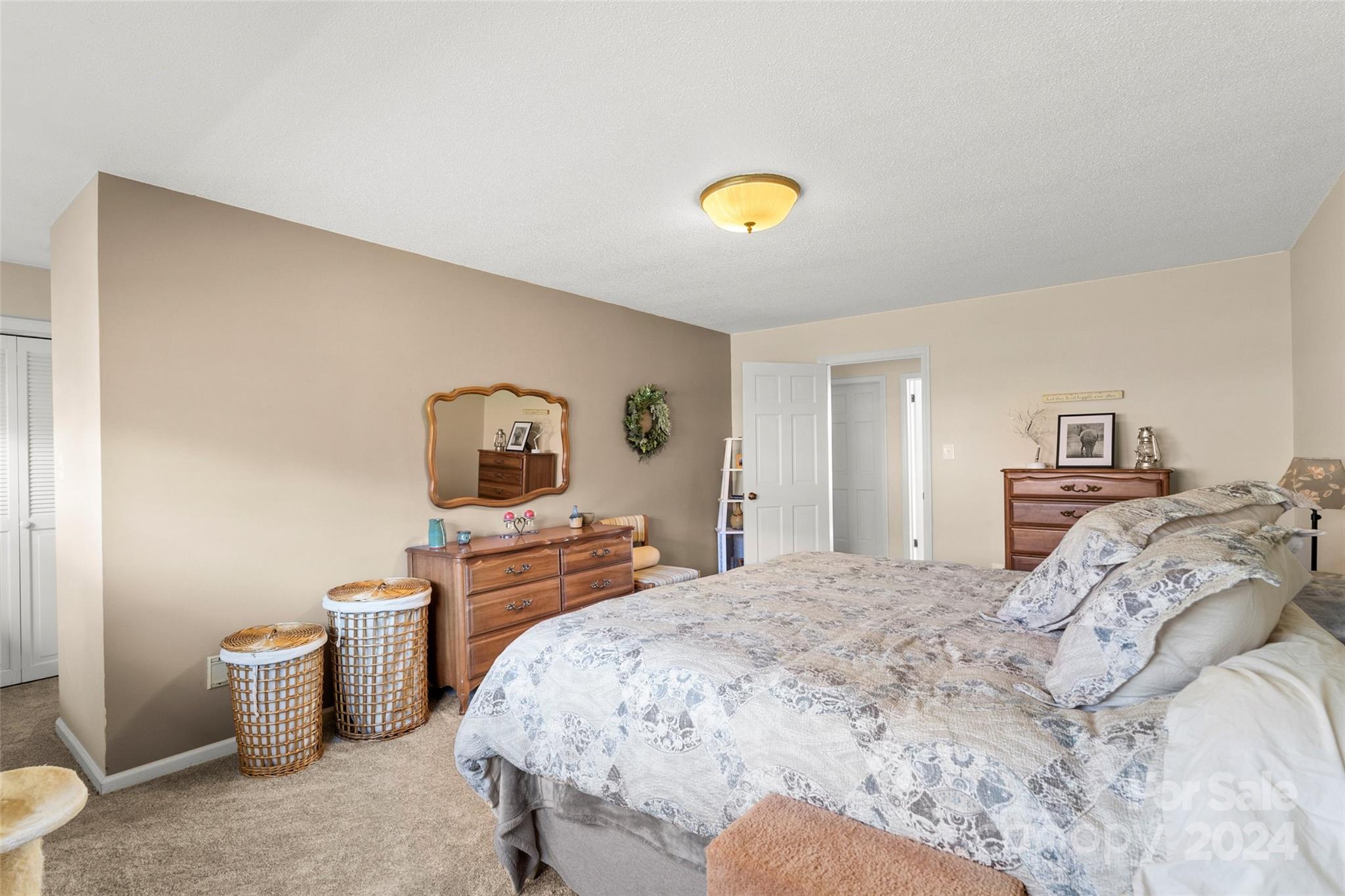 10845 Traphill Road Traphill, NC 28685 - Photo 22 of 48 a bedroom with a bed and a potted plant