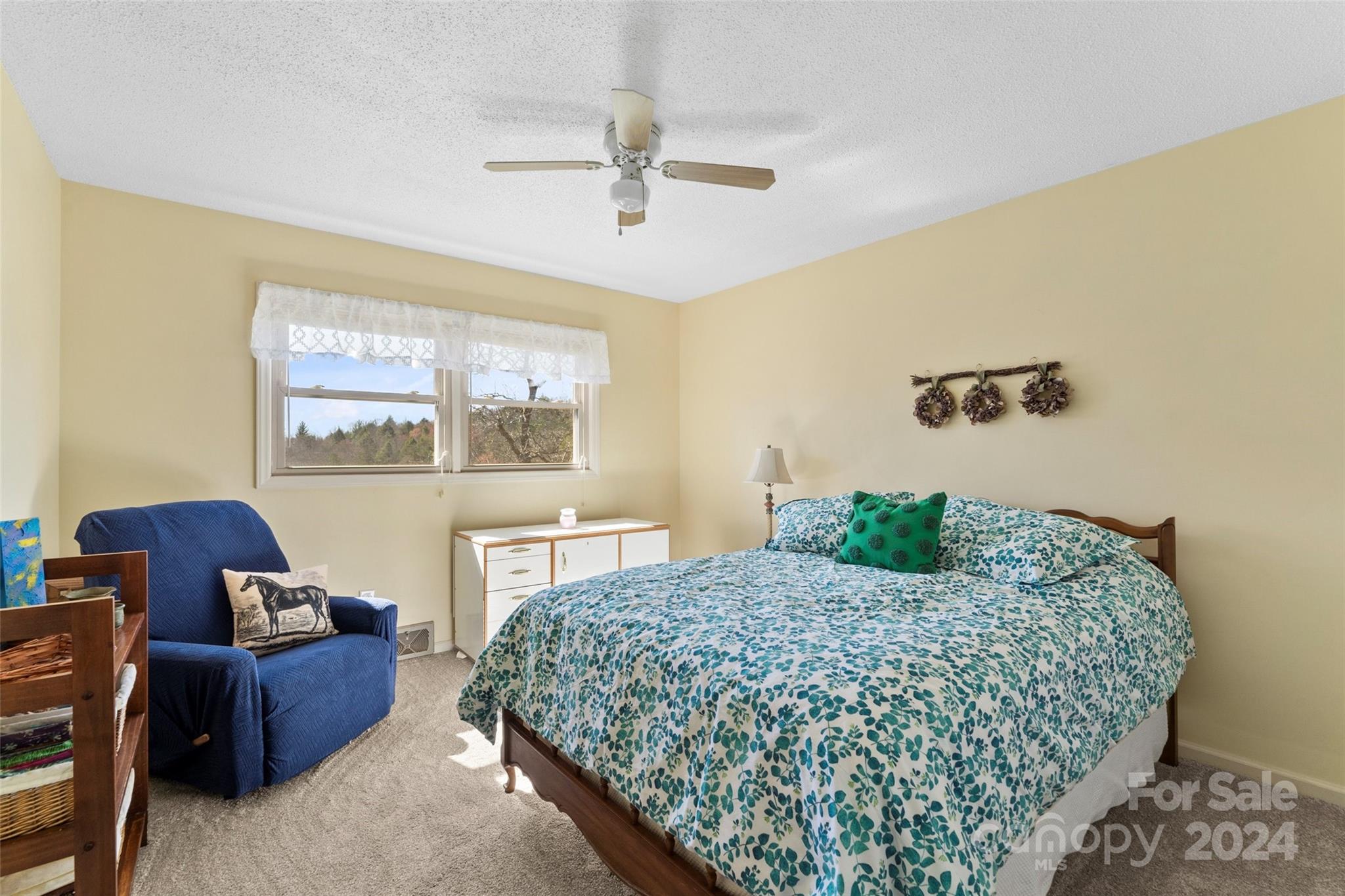 10845 Traphill Road Traphill, NC 28685 - Photo 24 of 48 a bedroom with a bed couch and window