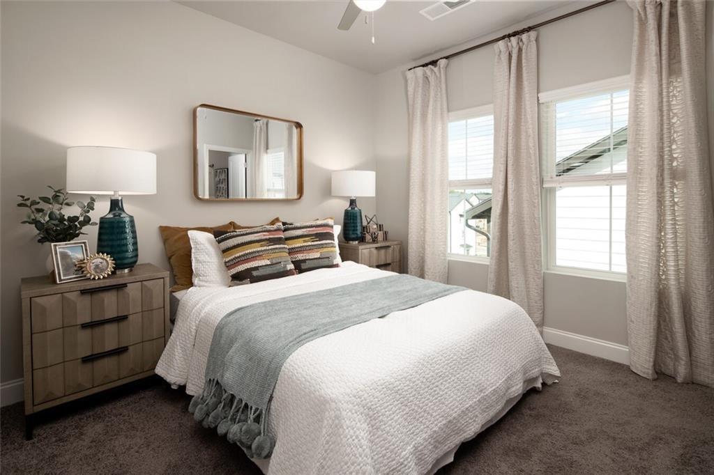 3960 Redan Road, Unit C1 Stone Mountain, GA 30083 - Photo 16 of 23 a bedroom with a bed and wooden floor