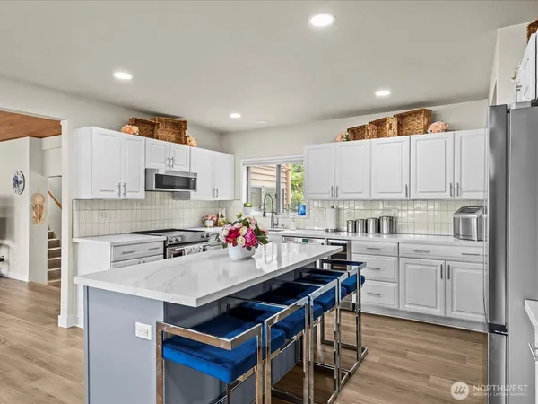 a kitchen with refrigerator a sink and cabinets