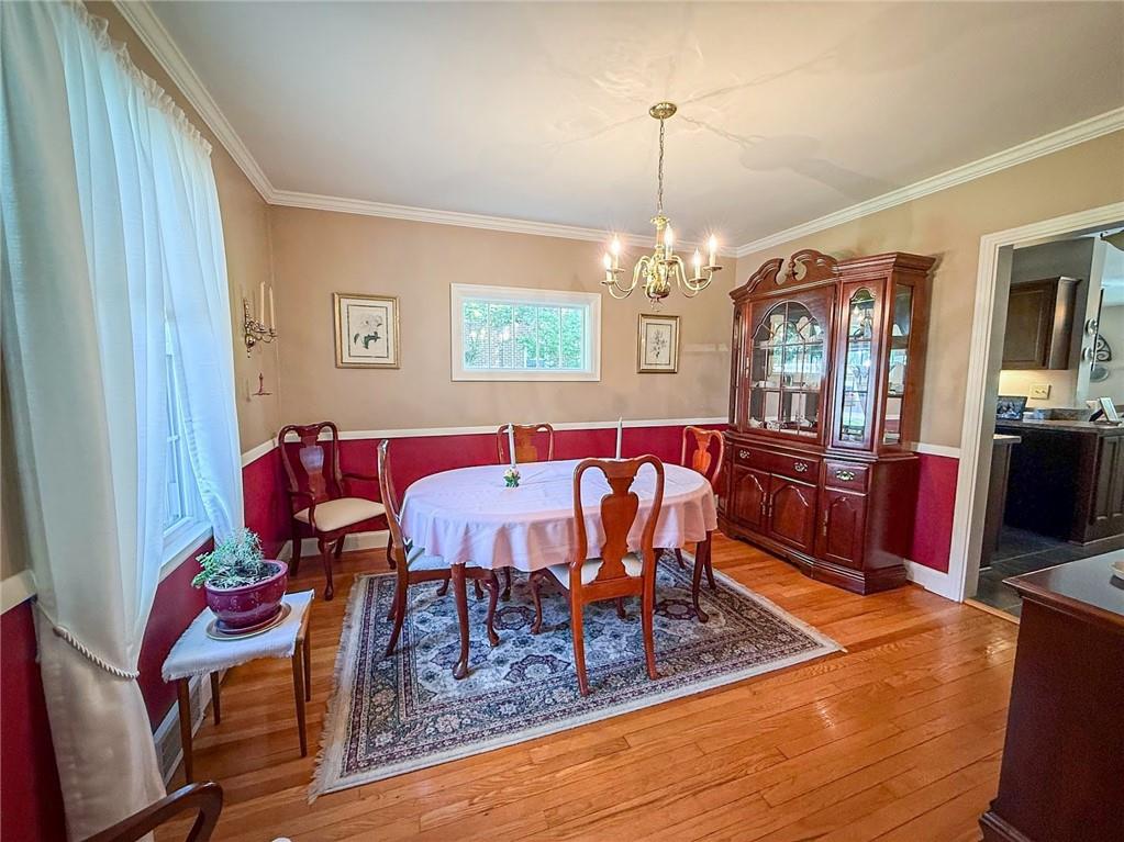 306 Beechwood Boulevard Butler, PA 16001 - Photo 11 of 40 a living room with furniture a dining table and a chandelier