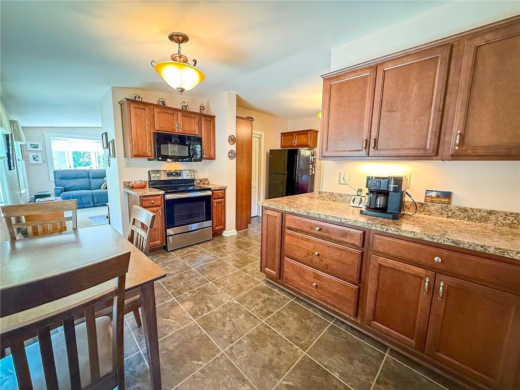 306 Beechwood Boulevard Butler, PA 16001 - Photo 13 of 40 a kitchen with granite countertop a sink dishwasher stove top oven and cabinets with wooden floor
