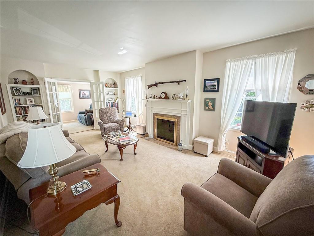 306 Beechwood Boulevard Butler, PA 16001 - Photo 2 of 40 a living room with furniture a flat screen tv and a fireplace