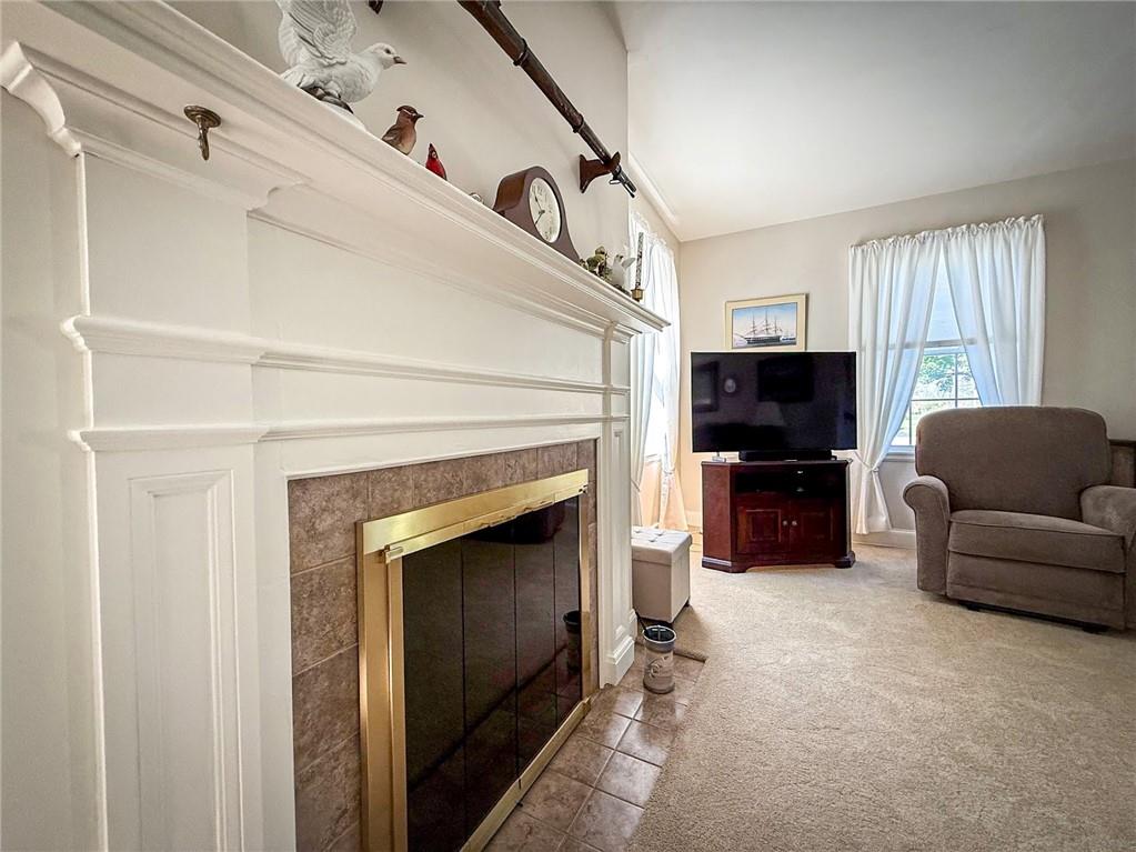 306 Beechwood Boulevard Butler, PA 16001 - Photo 7 of 40 a living room with furniture a flat screen tv and a fireplace