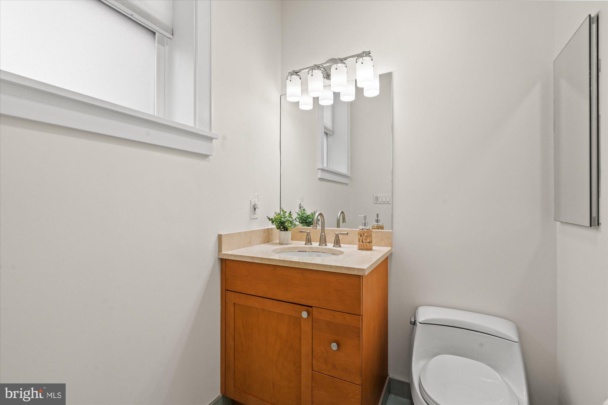 1817 Swann Street Northwest, Unit B Washington, DC 20009 - Photo 17 of 34 a bathroom with a toilet a sink and mirror