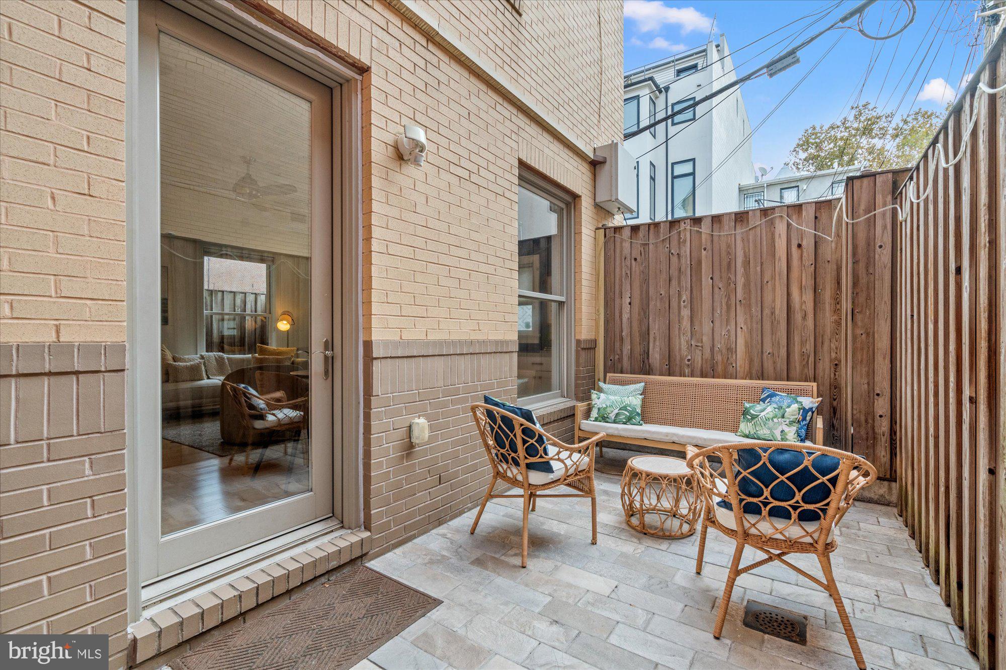 1817 Swann Street Northwest, Unit B Washington, DC 20009 - Photo 24 of 34 a backyard of a house with table and chairs