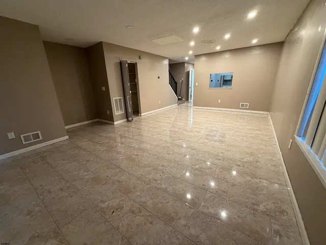 an empty room with closet and stairs