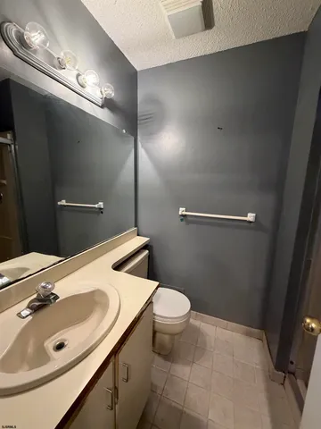 a bathroom with a sink toilet and a mirror