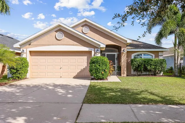 a front view of a house with a yard and garage
