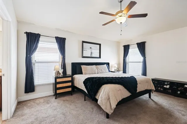 a spacious bedroom with a bed and a chandelier