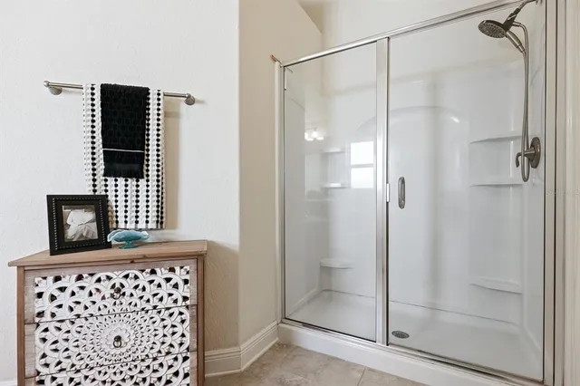 a bathroom with a shower and a mirror