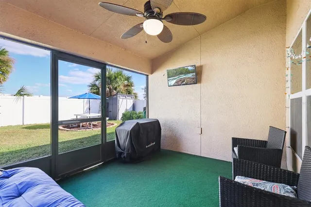 a living room with furniture and a floor to ceiling window