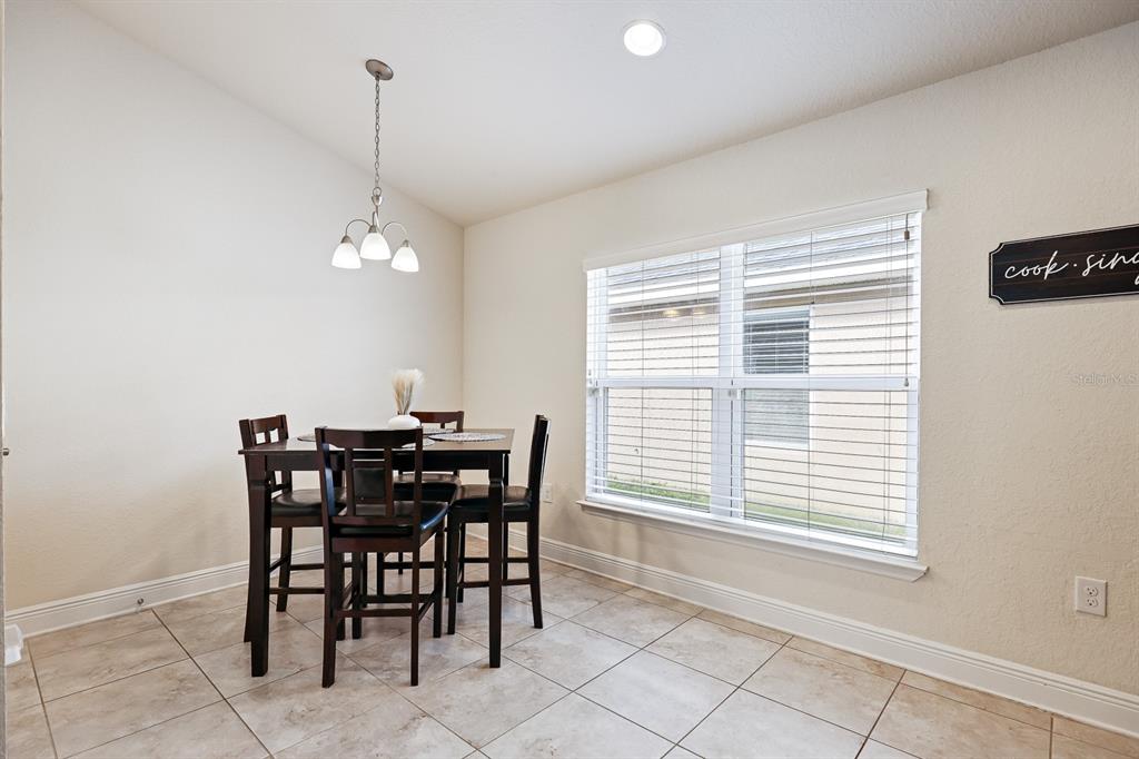 14510 Haddon Mist Drive Wimauma, FL 33598 - Photo 7 of 39 a view of a dining room with furniture and chandelier