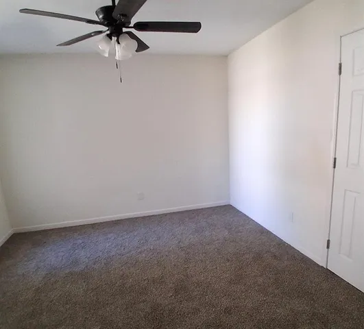 an empty room with a fan