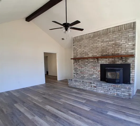 a room with a fireplace and a ceiling fan
