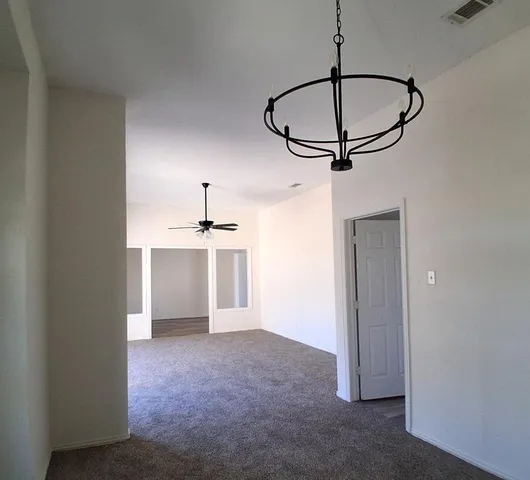a view of a room with a sink and cabinets