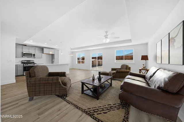 a living room with furniture or kitchen view and a wooden floor