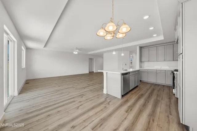 a view of kitchen with stove and wooden cabinets