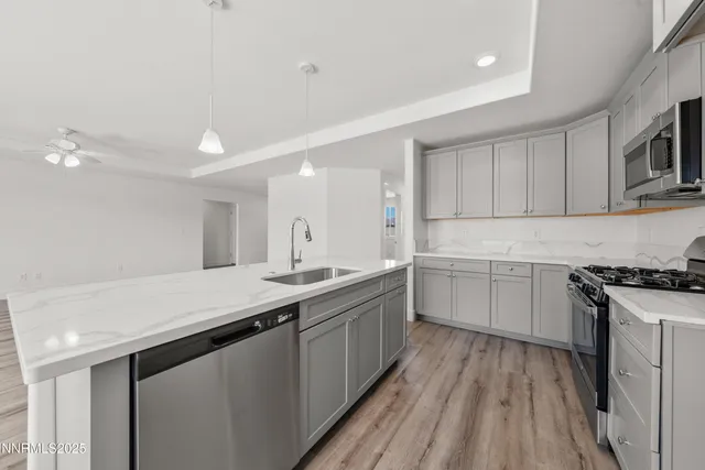 a kitchen with a sink stove and cabinets