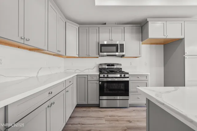a kitchen with cabinets stainless steel appliances and wooden cabinets