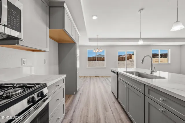a kitchen with sink stove and refrigerator