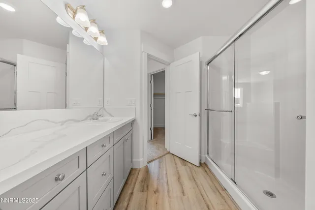 a bathroom with a double vanity sink and a mirror