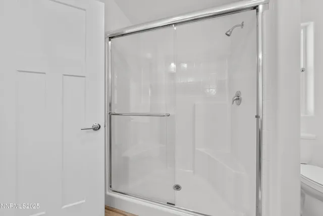 a bathroom with a glass shower door
