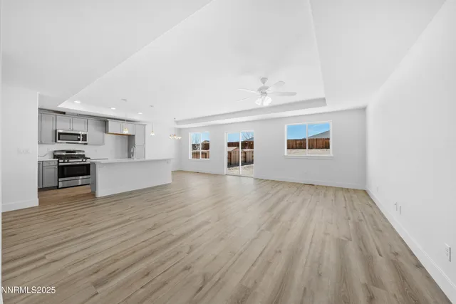 a view of a kitchen with wooden floor and a hallway