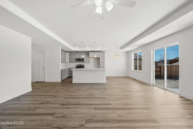 a view of a kitchen with wooden floor and a window