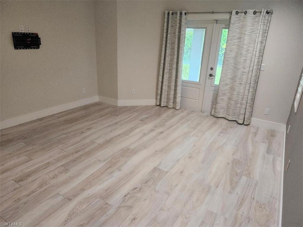 512 Raven Way Naples, FL 34110 - Photo 13 of 20 Empty room with wood finished floors and baseboards