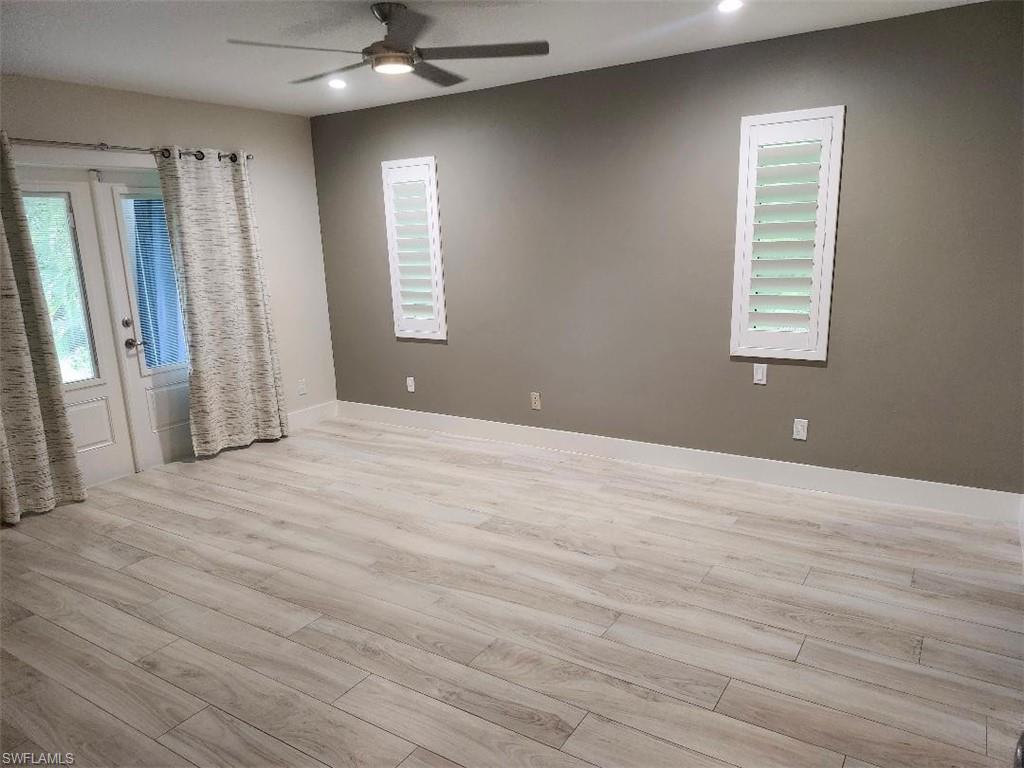512 Raven Way Naples, FL 34110 - Photo 14 of 20 Unfurnished room featuring light wood-type flooring, recessed lighting, and ceiling fan