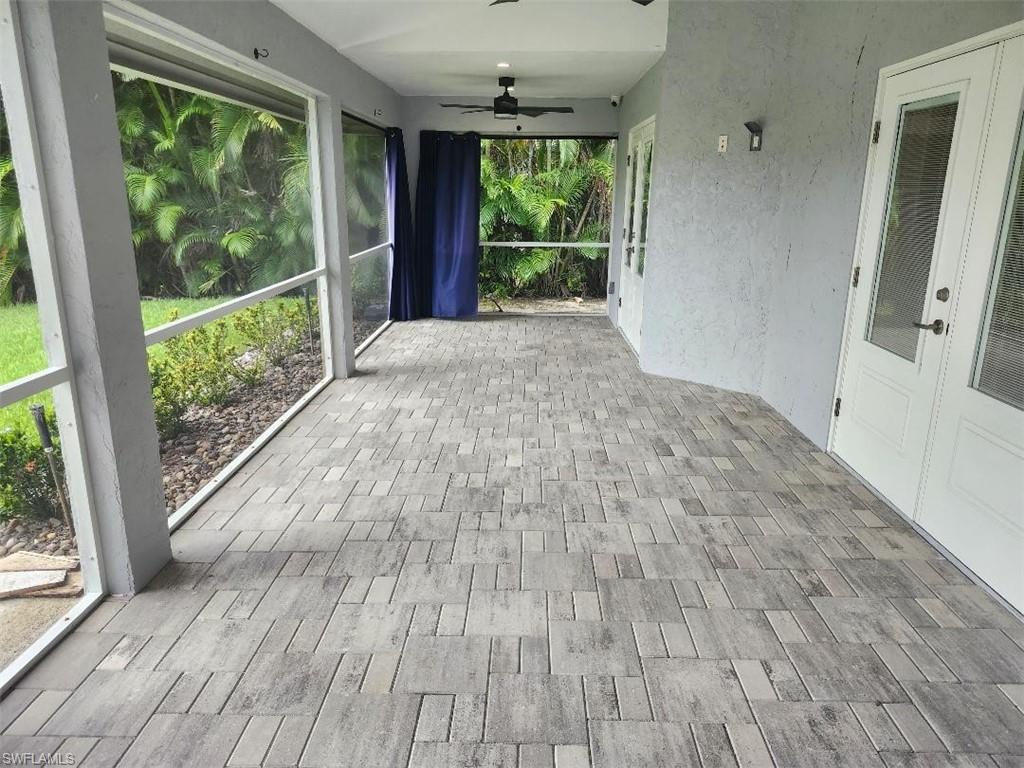 512 Raven Way Naples, FL 34110 - Photo 17 of 20 Unfurnished sunroom with ceiling fan