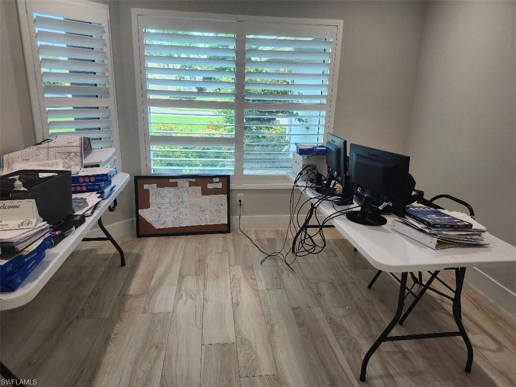 512 Raven Way Naples, FL 34110 - Photo 6 of 20 Home office with wood finished floors and baseboards